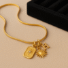 Gold-Tone Charm Necklace with Sun, Star, and Letter Pendants – Radiant Boho Luxe Style